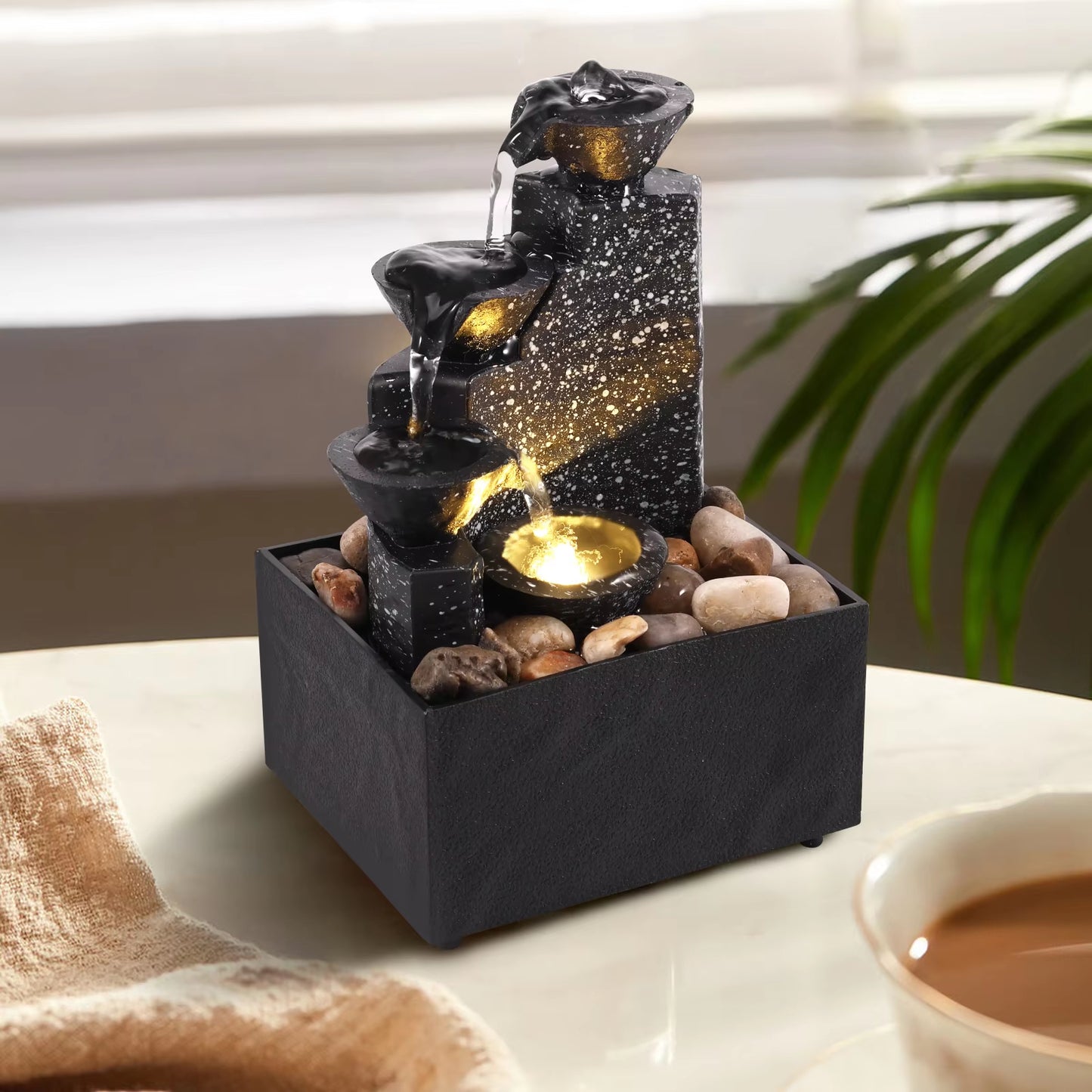 A stylish tabletop fountain featuring a soothing three-tier waterfall with warm LED lighting.
